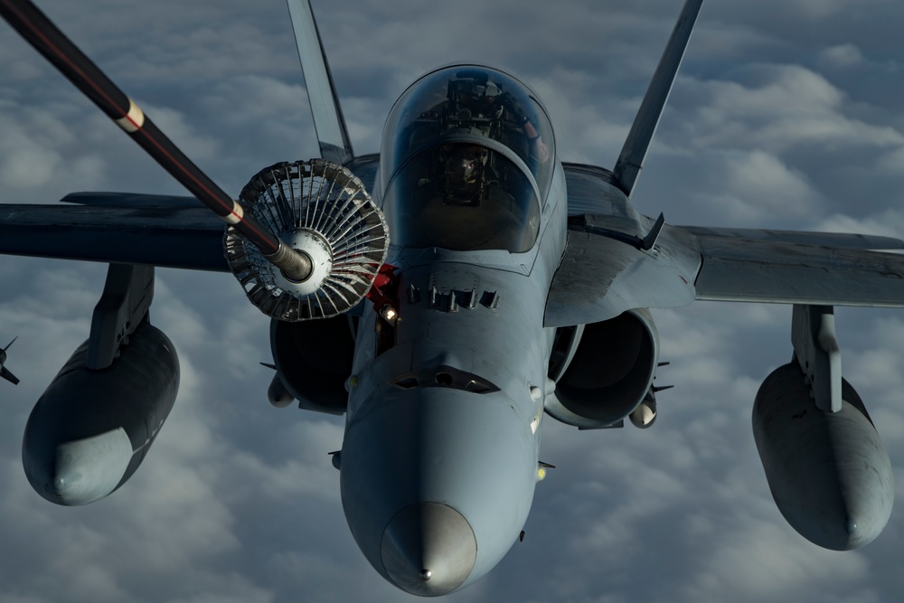 Deployed KC-10 refuels F/A-18 Hornets