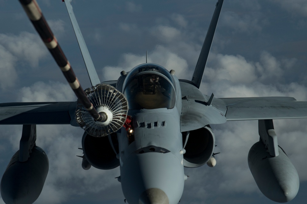 Deployed KC-10 refuels F/A-18 Hornets