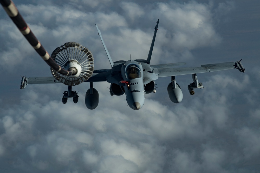 Deployed KC-10 refuels F/A-18 Hornets