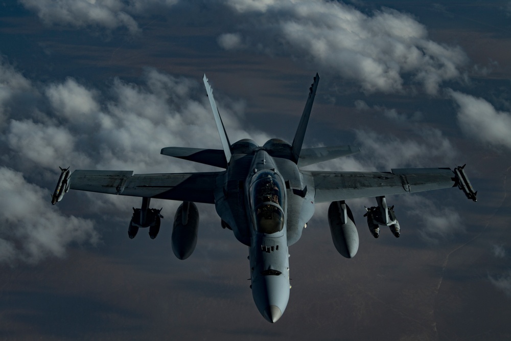 Deployed KC-10 refuels F/A-18 Hornets