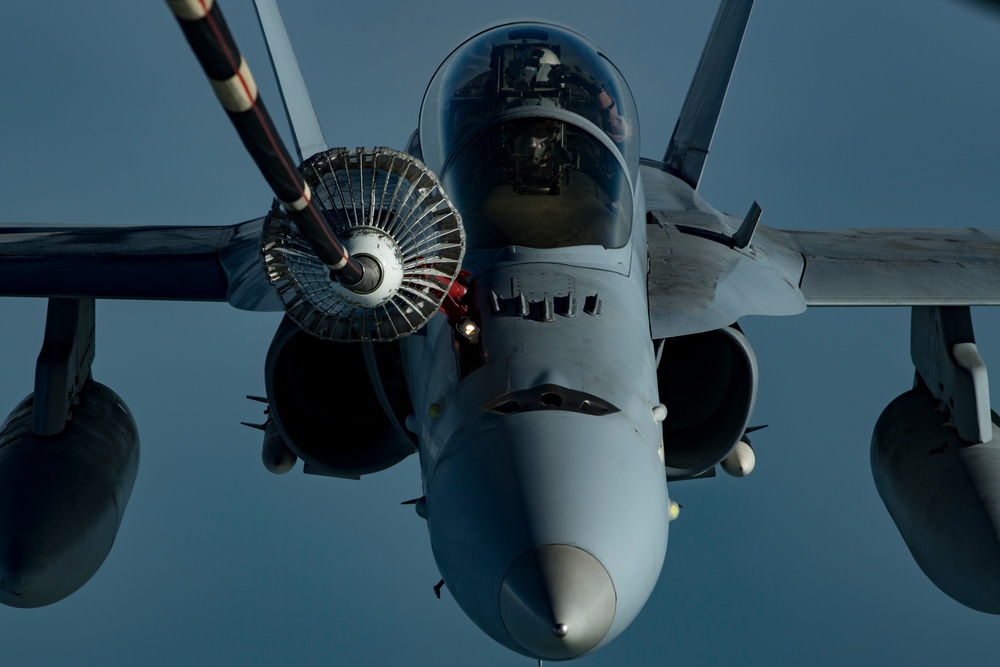 Deployed KC-10 refuels F/A-18 Hornets