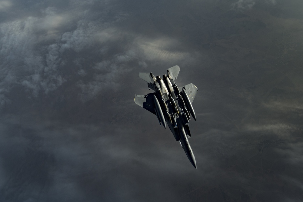 Deployed KC-10 refuels F-15 Strike Eagles