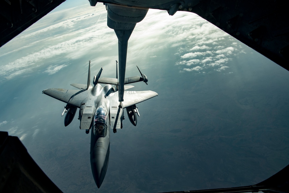 Deployed KC-10 refuels F-15 Strike Eagles