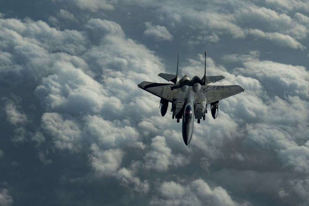 Deployed KC-10 refuels F-15 Strike Eagles