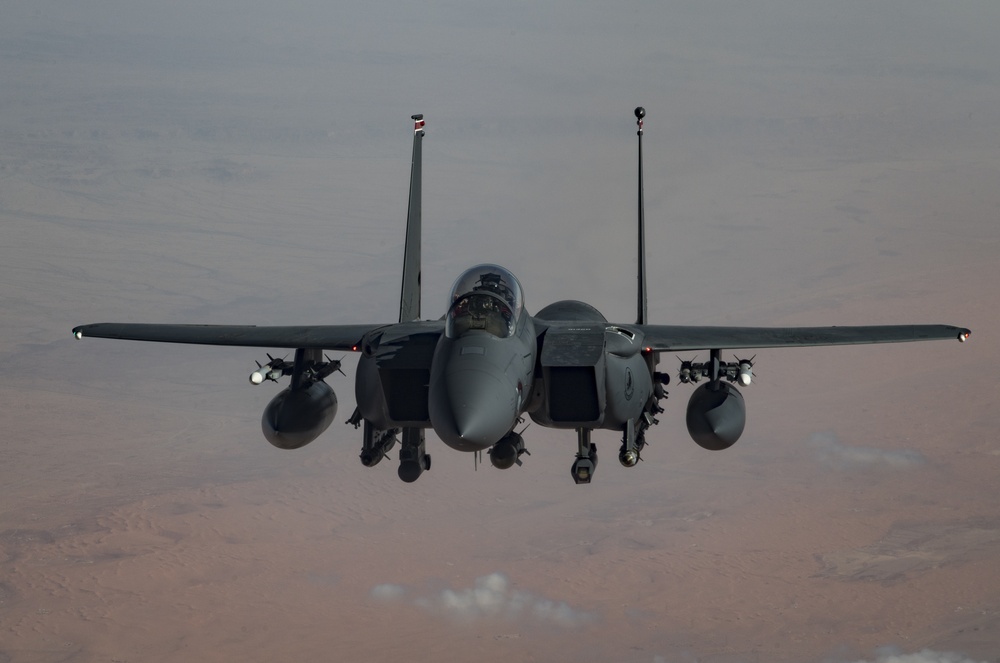 Deployed KC-10 refuels F-15 Strike Eagles