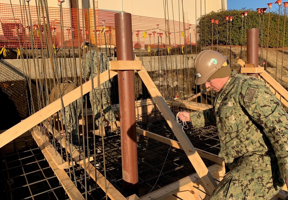 U.S. Navy Seabees deployed with NMCB-5's Detail Atsugi construct a loading dock at the Navy Exchange, Naval Air Facility Atsugi