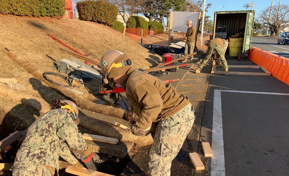 U.S. Navy Seabees deployed with NMCB-5's Detail Atsugi construct a loading dock