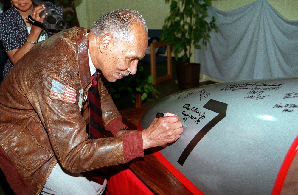 Dr. Roscoe C. Brown, Jr., member Tuskegee Airmen, signs a canopy modeled after his P51 D Mustang