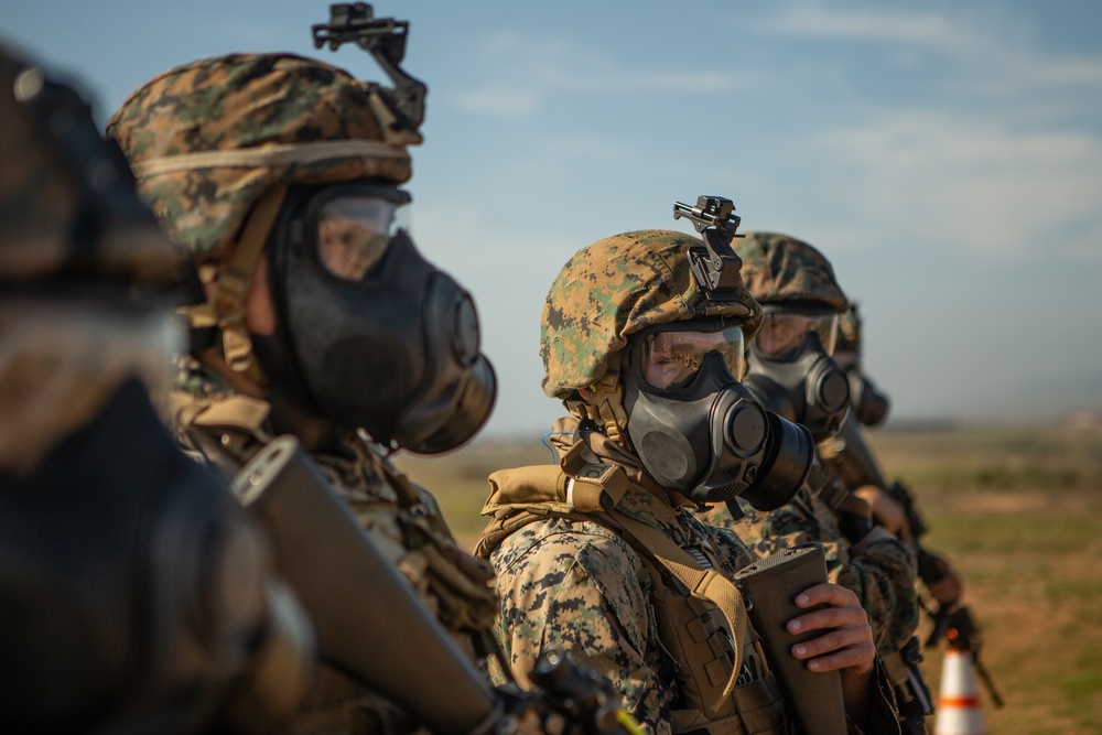 Marines test shooting capabilities with M-50 field protective mask