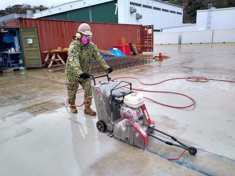 U.S. Navy Seabees with NMCB-5’s Detail Sasebo construct two pre-engineered buildings for NBU-7