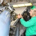 USS Normandy Sailor Performs Maintenance On MH-60R Sea Hawk Helicopter