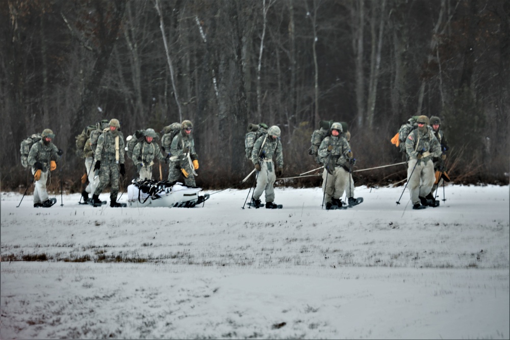 Fort McCoy Cold-Weather Operations Course students practice snowshoeing, ahkio sled use