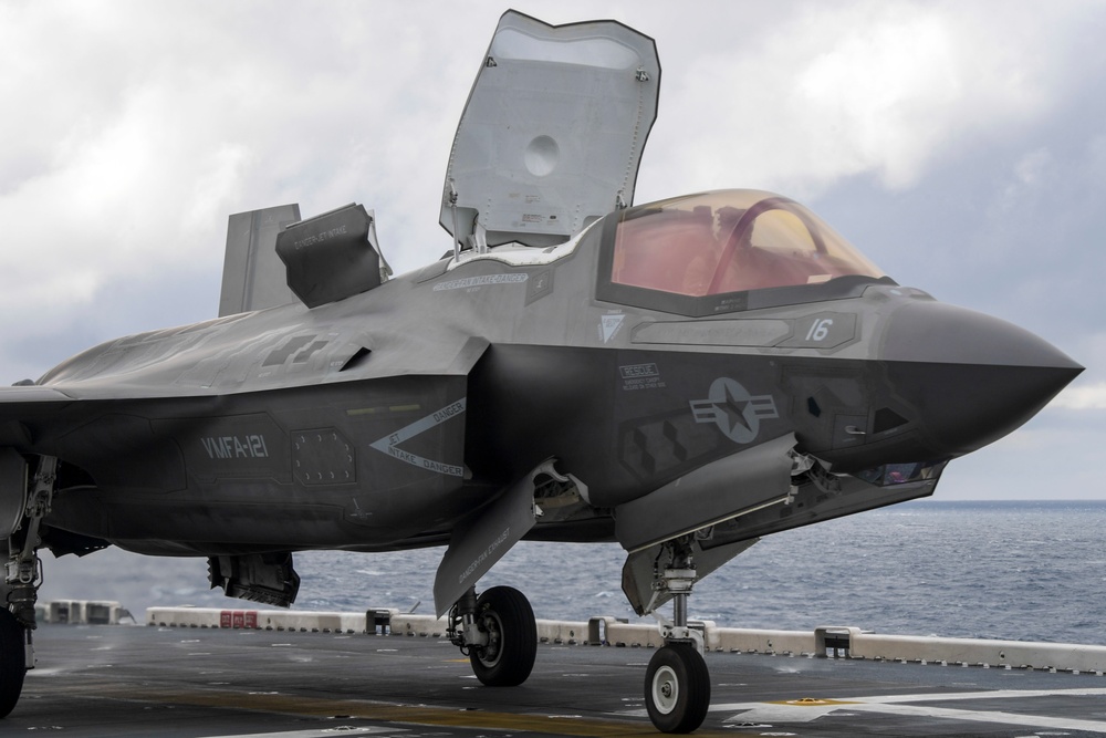 Aviation Boatswain's Mates signal aircraft to take off of the flight deck of amphibious assault ship USS America (LHA 6)