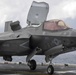 Aviation Boatswain's Mates signal aircraft to take off of the flight deck of amphibious assault ship USS America (LHA 6)