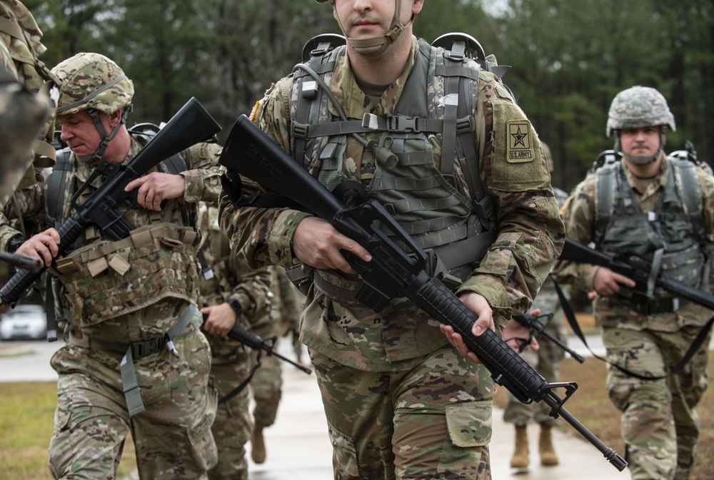 Warrant officer candidates ruck march for course requirement