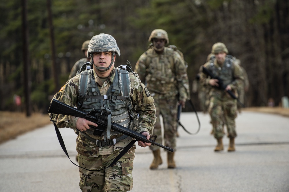 Warrant officer candidates ruck march for course requirement