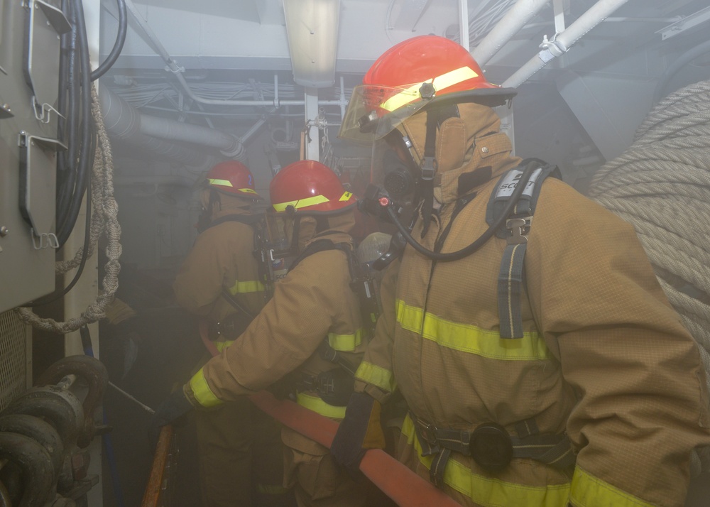 Sailors Man Fire Hose During General Quarters Drill