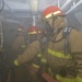 Sailors Man Fire Hose During General Quarters Drill