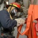 Sailor Restows Fire Hose During General Quarters Drill