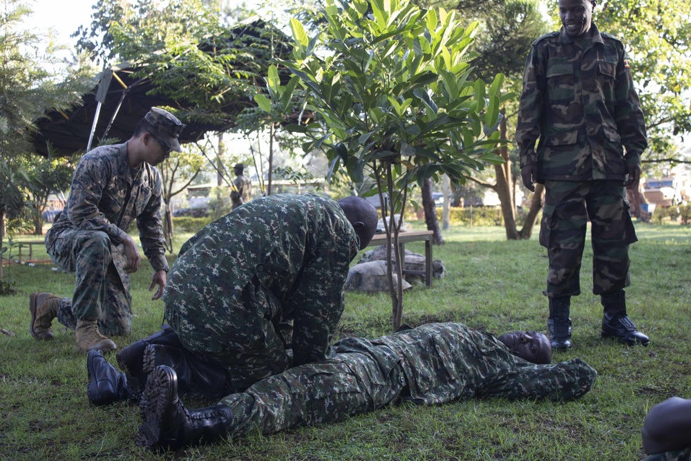 A U.S. Navy Sailor Advises Members of the Uganda People's Defence Force