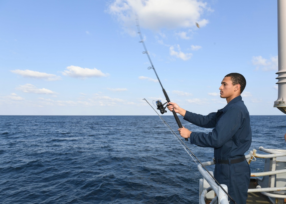 USS Normandy Sailor Fishes During Holiday Routine