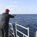 USS Normandy Sailor Fishes During Holiday Routine