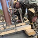 U.S. Navy Seabees with NMCB-5's Detail Atsugi construct a loading dock at the Navy Exchange
