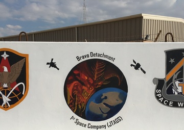 NCO wields paintbrush to help unit