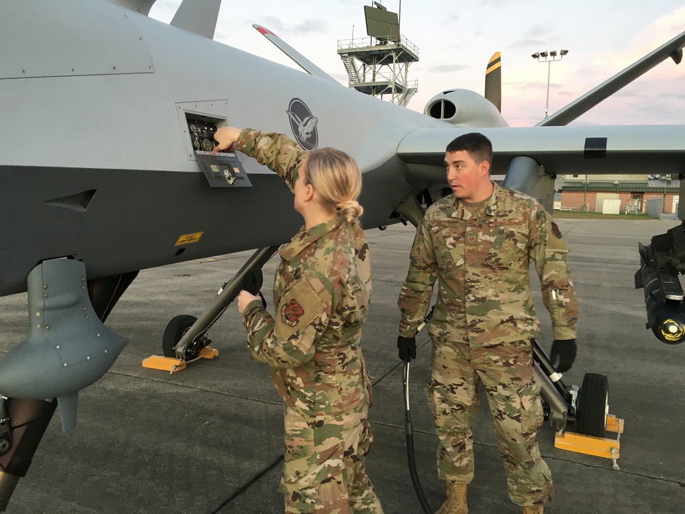 119th Wing Maintenance Squadron personnel conduct pre-flight checks on an MQ-9 Reaper aircraft