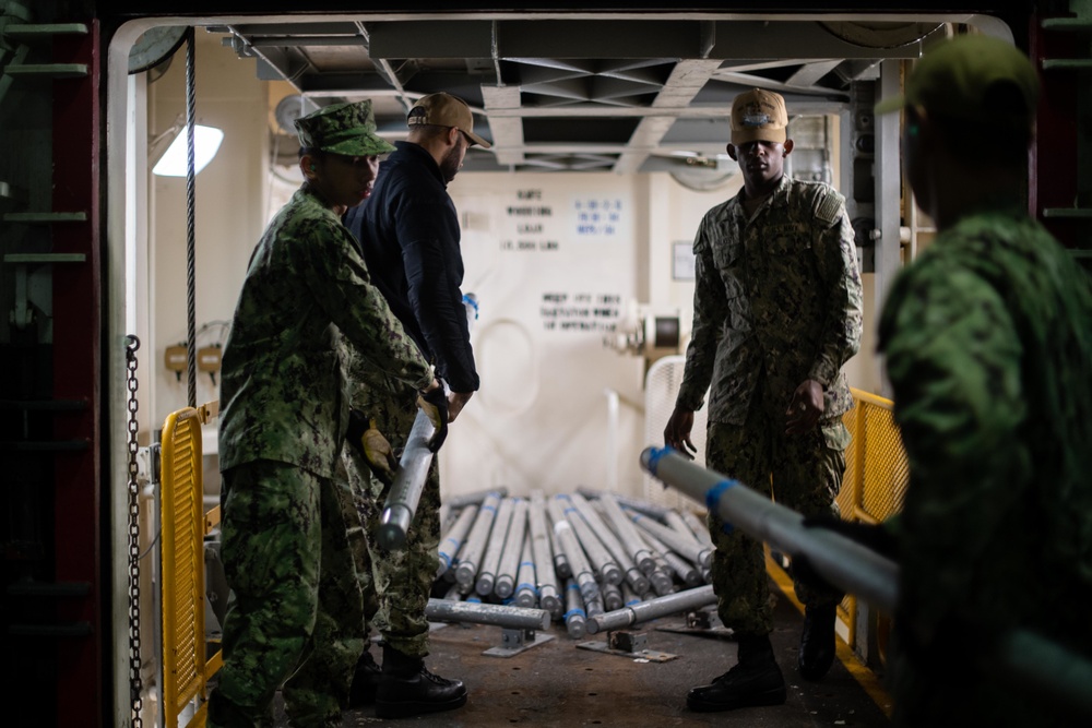 U.S. Sailors load a weapons elevator