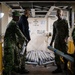 U.S. Sailors load a weapons elevator