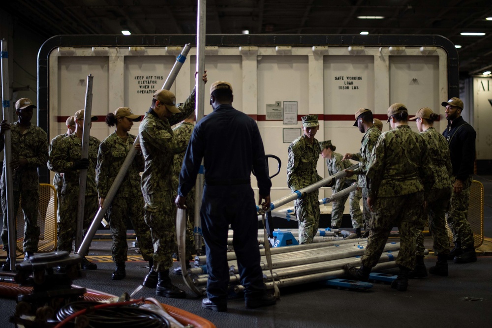 U.S. Sailors unload a weapons elevator