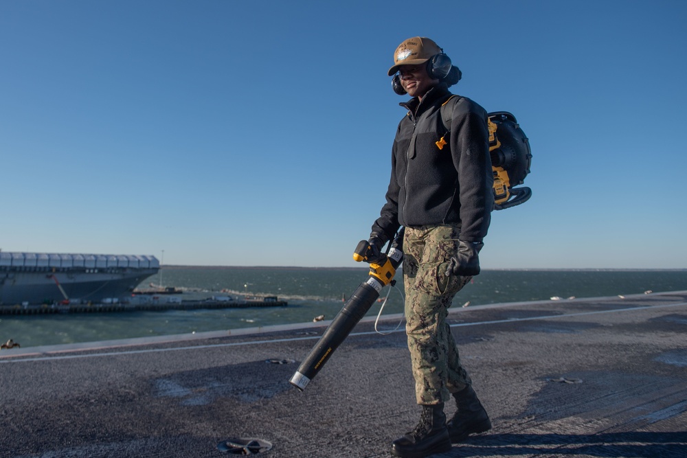 U.S. Sailor cleans flight deck