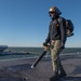 U.S. Sailor cleans flight deck
