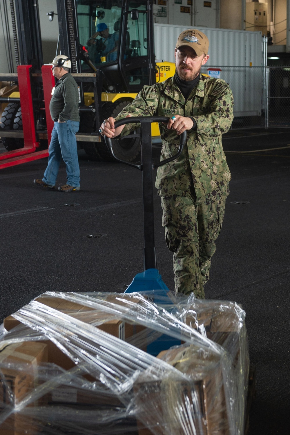 U.S. Navy Aviation Machinist’s Mate 3rd Class Dylan Eaton, from Locus Grove, Oklahoma, moves a pallet in preparation for a hazardous material offload aboard the aircraft carrier USS John C. Stennis (CVN 74) in Norfolk, Virginia, Jan. 14, 2020.