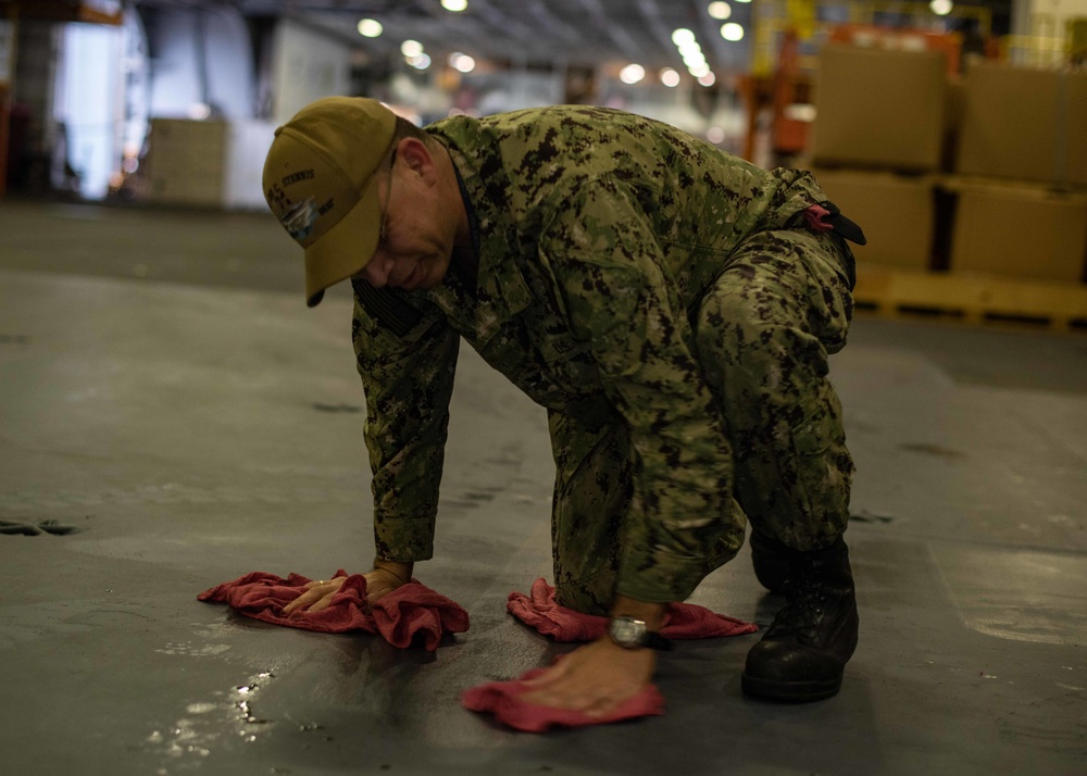 U.S Sailor cleans oil