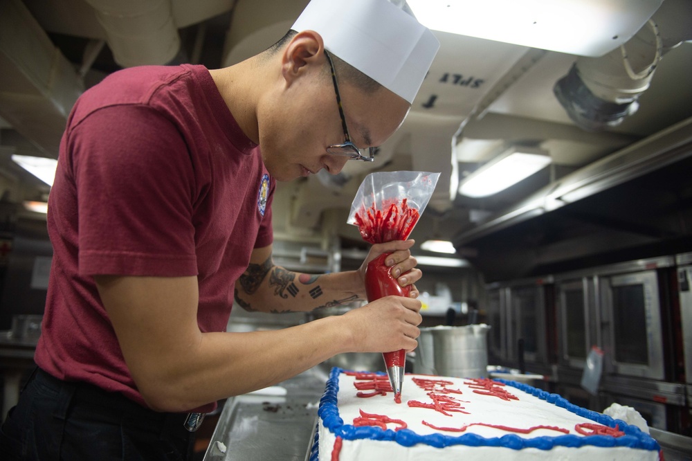 Sailor decorates cake.
