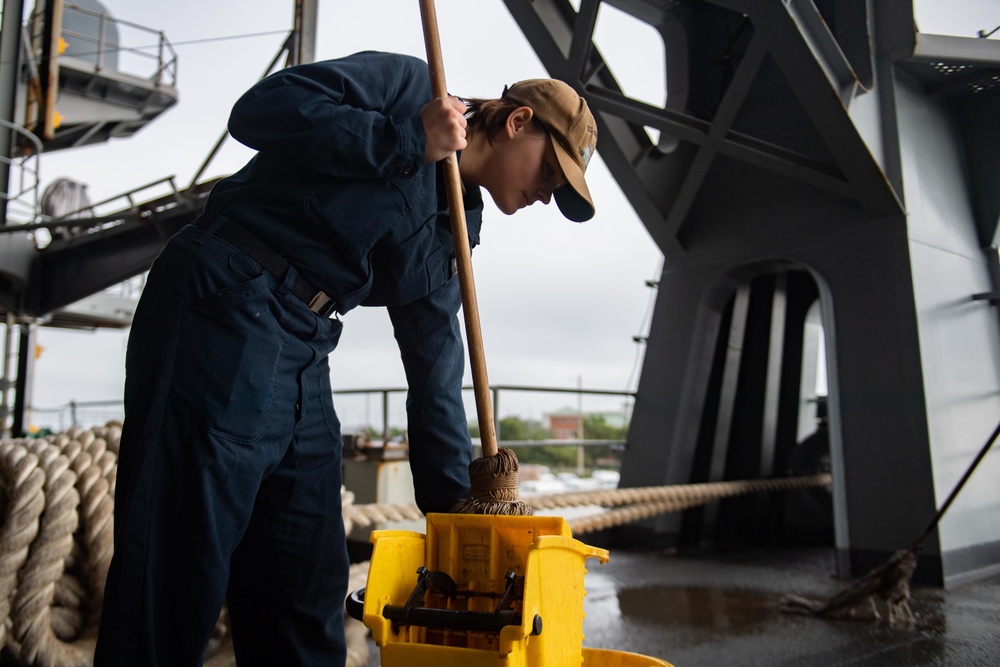 U.S. Sailor cleans the fantail of the USS John C. Stennis