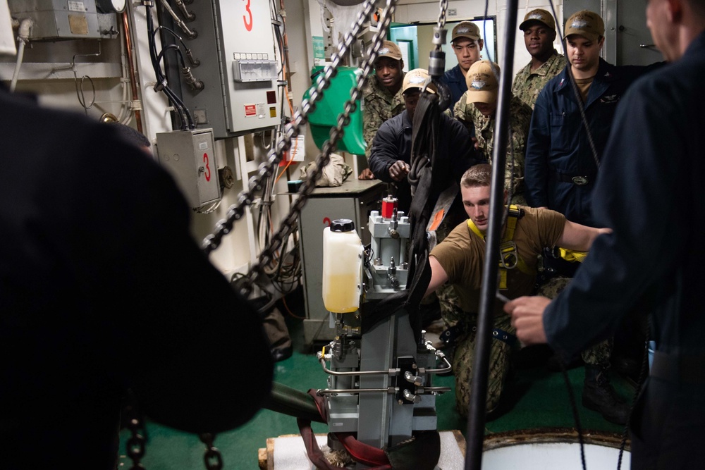 U.S. Sailors prepare to lower reactor frame