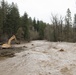 An excavator removes debris from the Mill Creek Channel