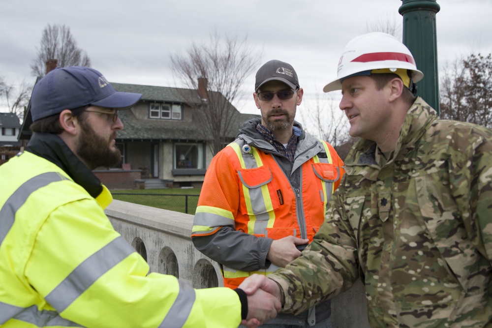 Lt. Col. Christian Dietz, Commander of the Walla Walla District Corps of Engineers greets Walla Walla City workers who are monitoring the Mill Creek Channel