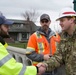 Lt. Col. Christian Dietz, Commander of the Walla Walla District Corps of Engineers greets Walla Walla City workers who are monitoring the Mill Creek Channel
