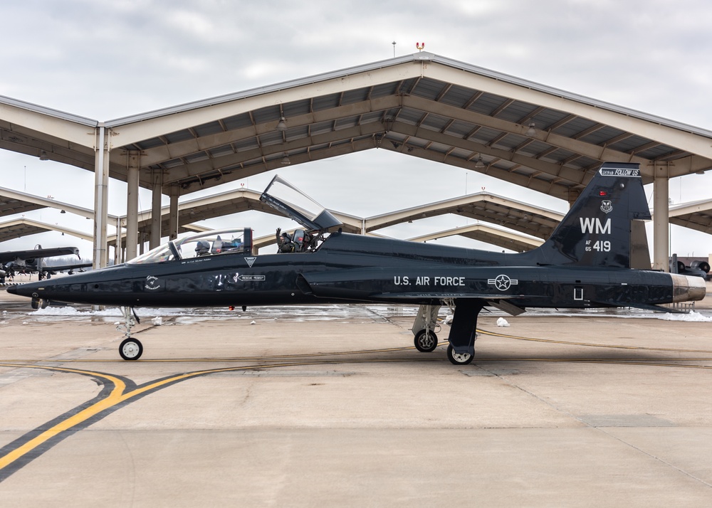 509th Healthcare Operations Squadron Airman of the Year waves from a T-38 Talon