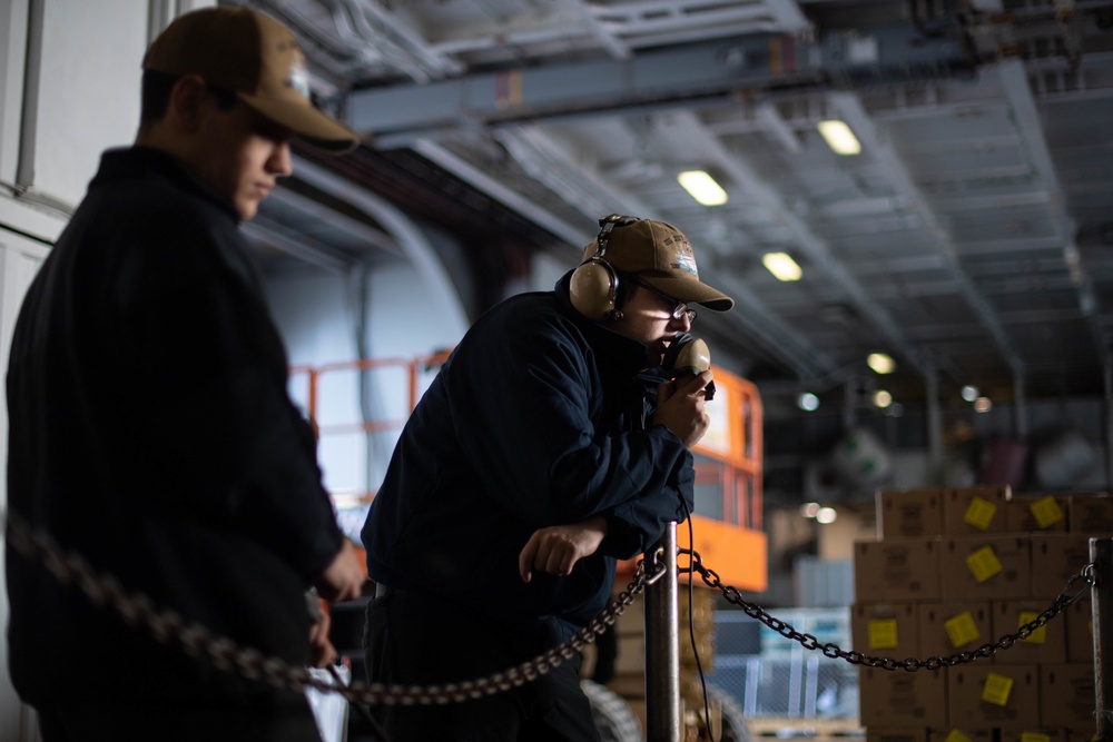 U.S. Sailor speaks through a sound-powered phone