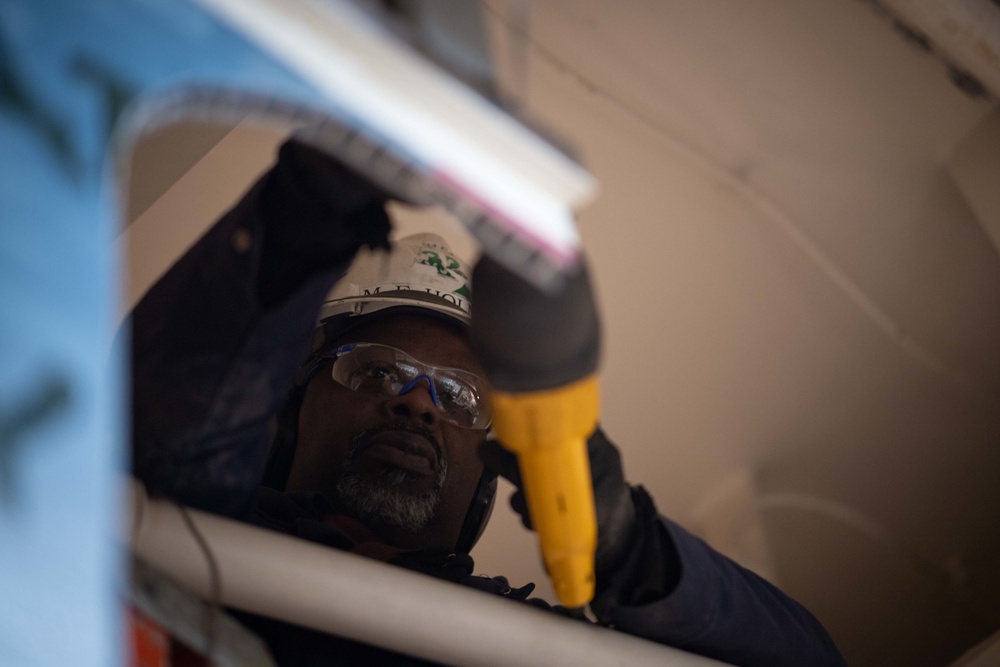 U.S Navy Newport News Shipbuilding contractor operates a saw