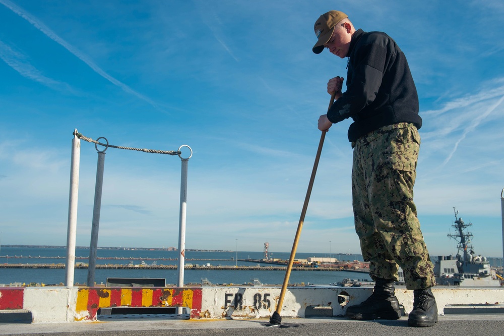 A Sailor cleans