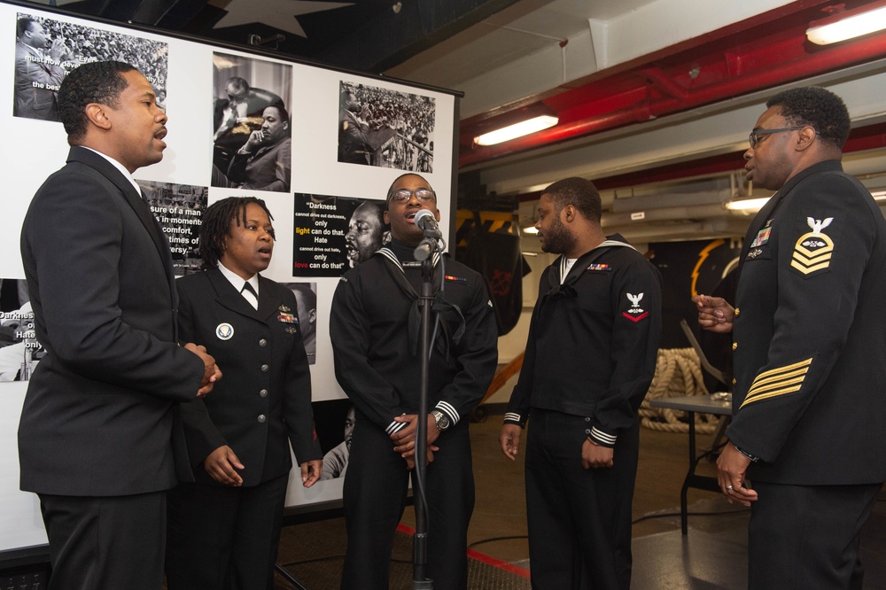 U.S. Navy Sailors from the multi-cultural committee sing at the Dr. Martin Luther King Jr. ceremony in the forecastle aboard the aircraft carrier USS John C. Stennis (CVN 74) in Norfolk, Virginia, Jan. 28, 2020.