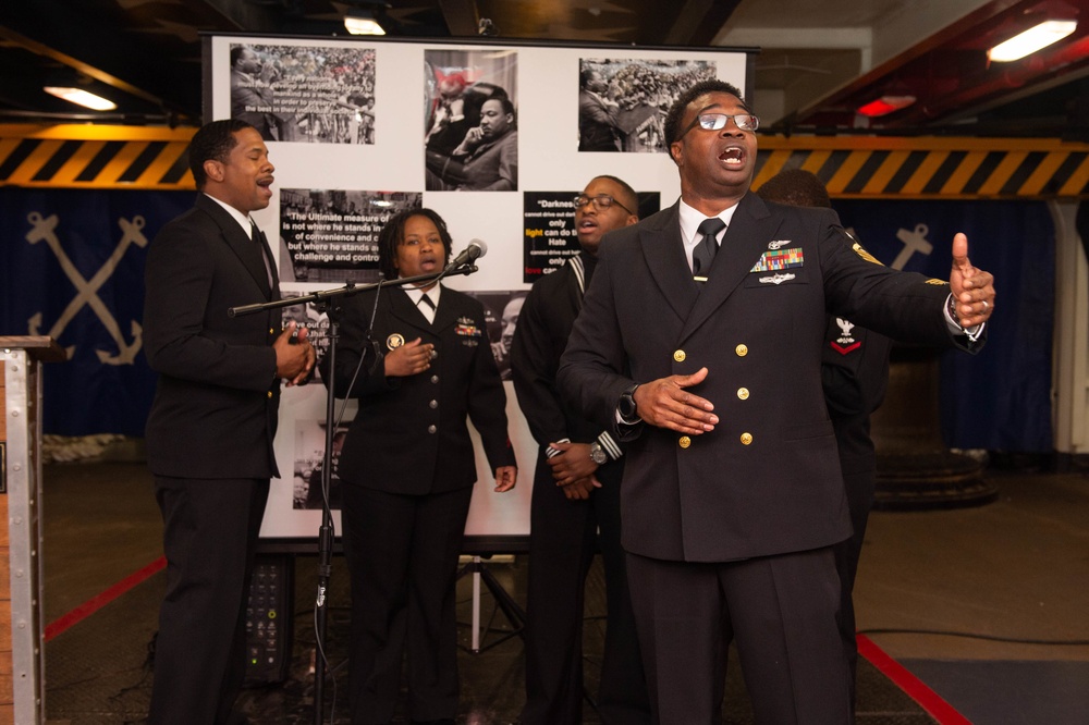 U.S. Navy Chief Aviation Boatswain’s Mate (Equipment) Harrison Moorer, from Sanford, Florida, sings during the multi-cultural committee’s Dr. Martin Luther King Jr. ceremony in the forecastle.