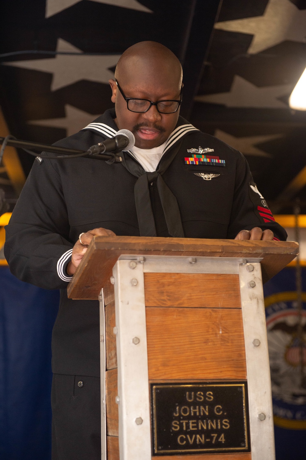 U.S. Navy Culinary Specialist 1st Class Fred White, from Jonesville, Florida, reads aloud at the multi-cultural committee’s Dr. Martin Luther King Jr. ceremony in the forecastle