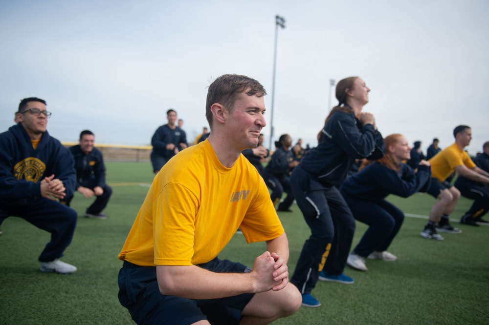 U.S. Sailors squat during command physical training for the aircraft carrier USS John C. Stennis (CVN 74 in Norfolk, Virginia, Jan. 31, 2020.